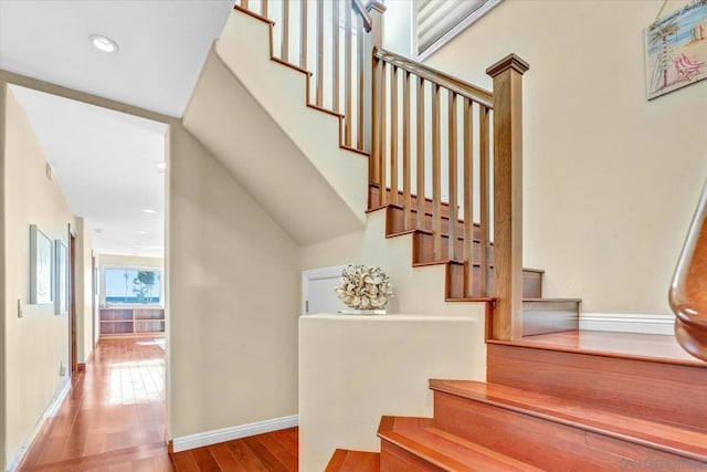 stairway with hardwood / wood-style flooring