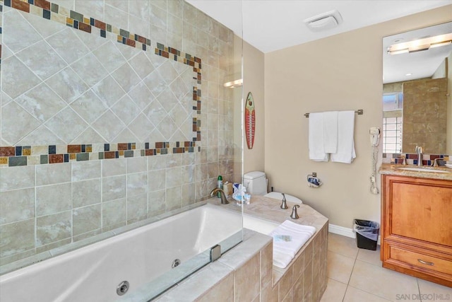 bathroom with toilet, tile patterned flooring, a relaxing tiled tub, and vanity