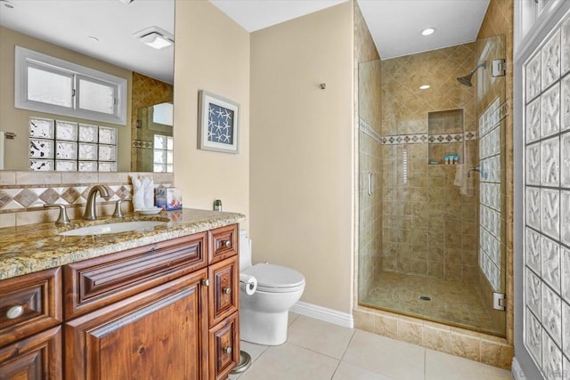 bathroom with toilet, a shower with shower door, tile patterned floors, and vanity