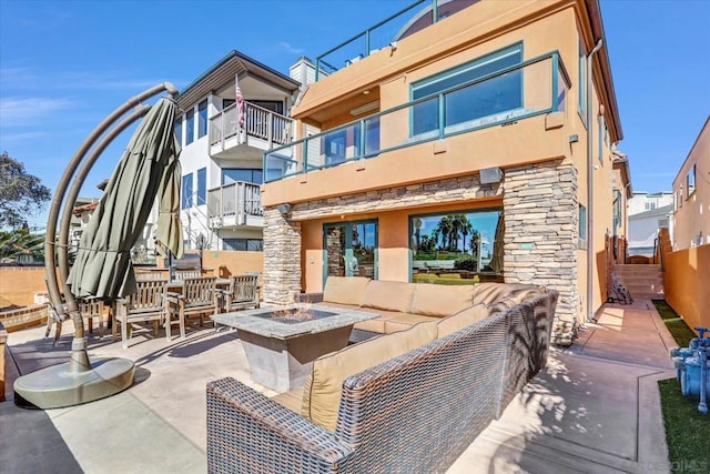 view of patio / terrace featuring an outdoor living space with a fire pit