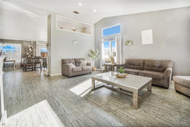 living room with vaulted ceiling and hardwood / wood-style flooring