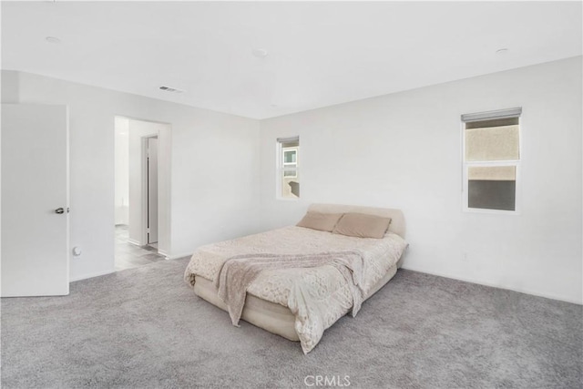 bedroom featuring light carpet