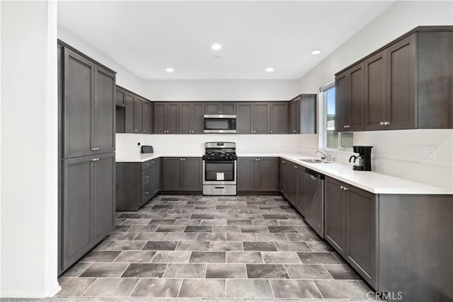 kitchen featuring sink, stainless steel appliances, and dark brown cabinetry