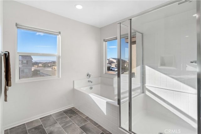 bathroom with tile patterned flooring, a healthy amount of sunlight, and separate shower and tub