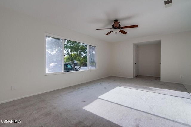 carpeted empty room featuring ceiling fan