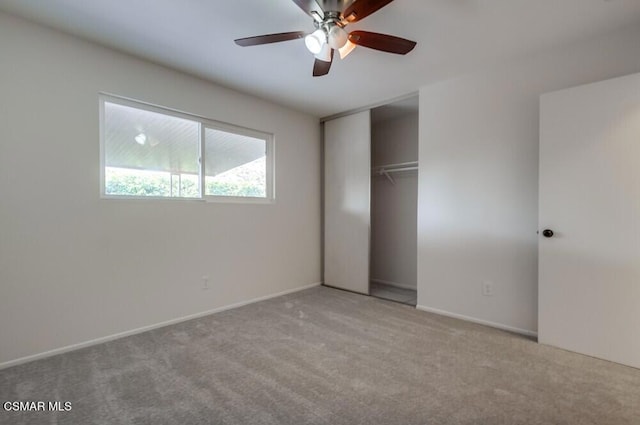 unfurnished bedroom featuring ceiling fan, light colored carpet, and a closet