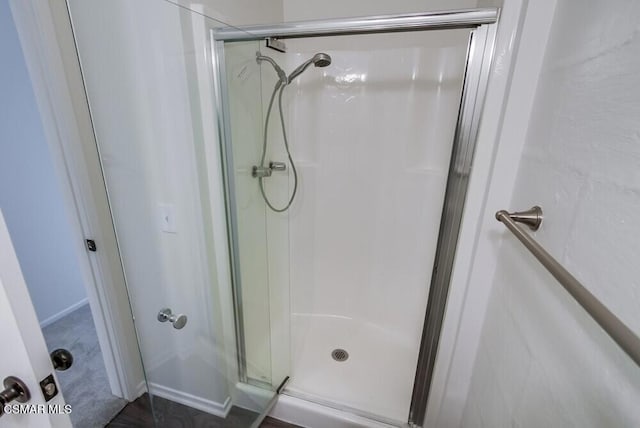 bathroom with a shower with door