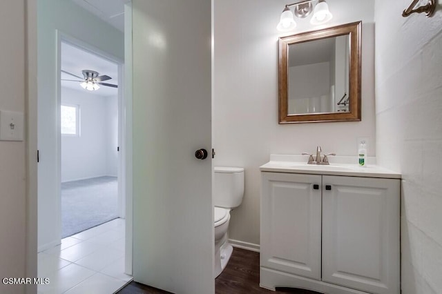 bathroom featuring ceiling fan, vanity, and toilet