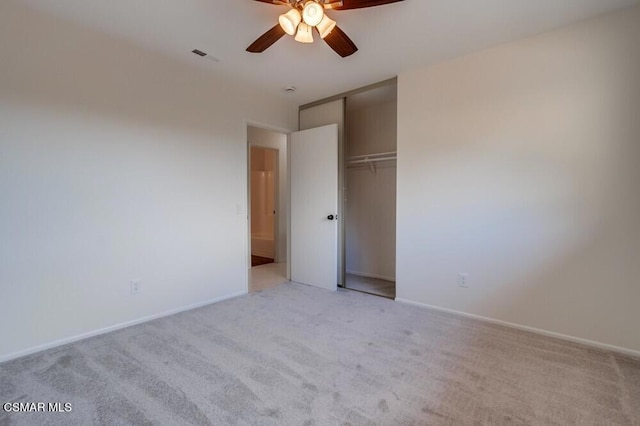 unfurnished bedroom featuring ceiling fan, light colored carpet, and a closet