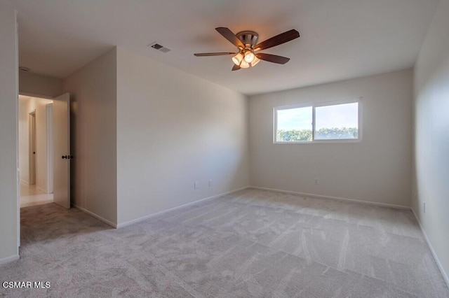 spare room featuring ceiling fan and light colored carpet