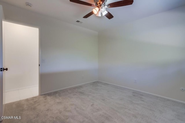 carpeted spare room with ceiling fan