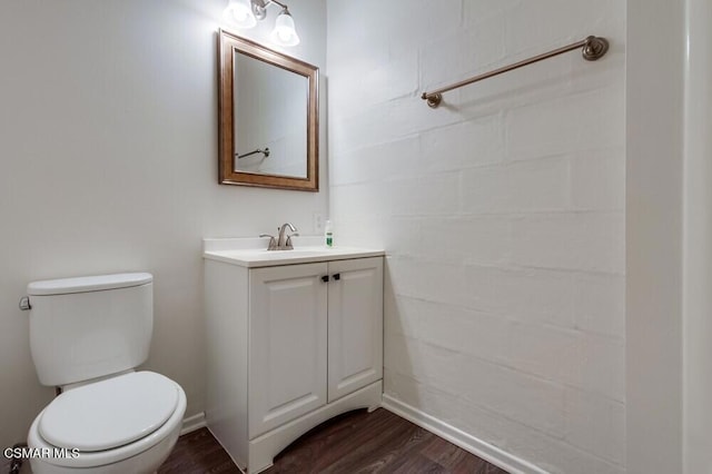 bathroom featuring hardwood / wood-style flooring, vanity, and toilet