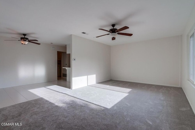 unfurnished room with ceiling fan and light colored carpet