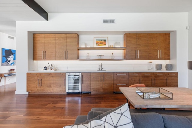 bar with wine cooler and dark hardwood / wood-style floors