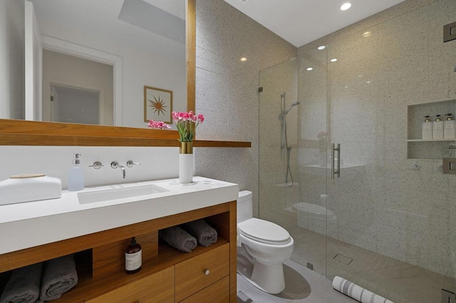 bathroom with an enclosed shower, vanity, tile patterned floors, and toilet