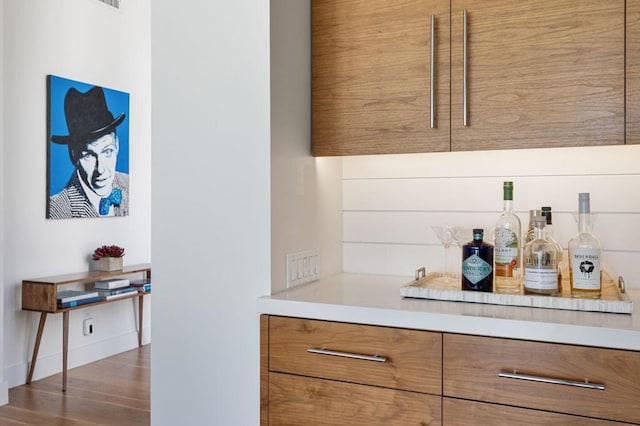 bar with dark hardwood / wood-style floors