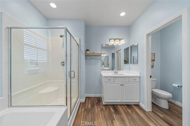 bathroom with a shower with shower door, wood-type flooring, toilet, and vanity