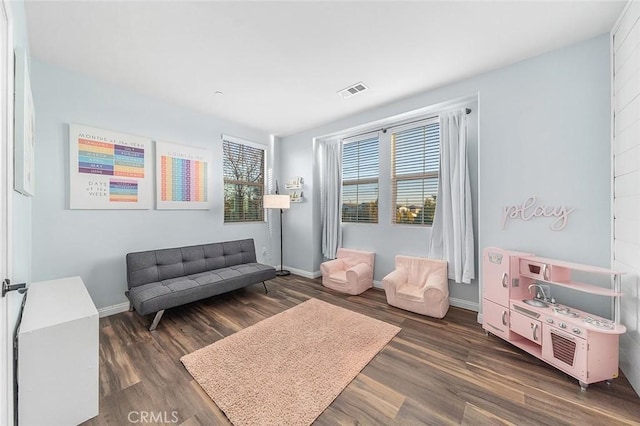 sitting room with dark wood-type flooring