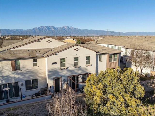 back of house featuring a mountain view