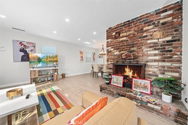 living room featuring wood-type flooring and a fireplace