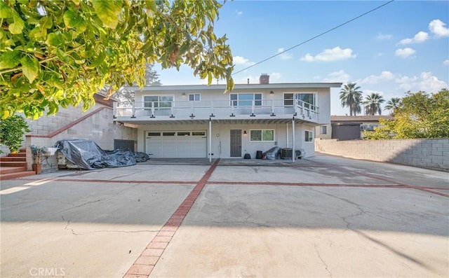 view of front of property with a garage and a balcony