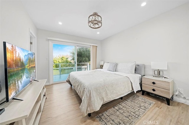 bedroom with access to exterior and light wood-type flooring