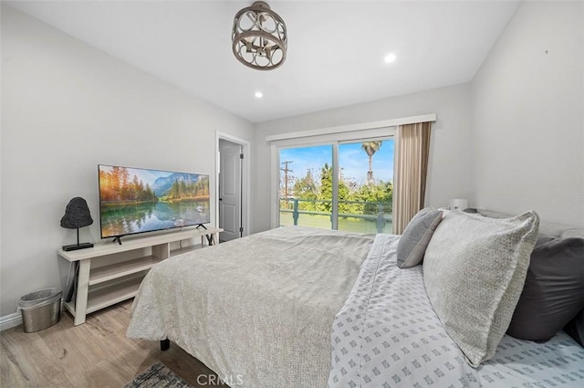 bedroom featuring access to exterior and light hardwood / wood-style flooring