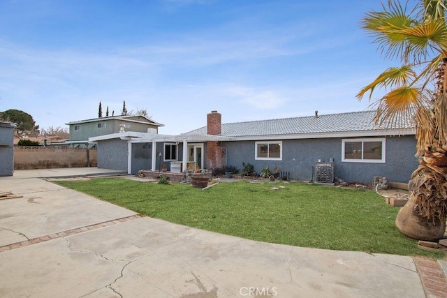 exterior space with a front yard, concrete driveway, a patio area, and fence