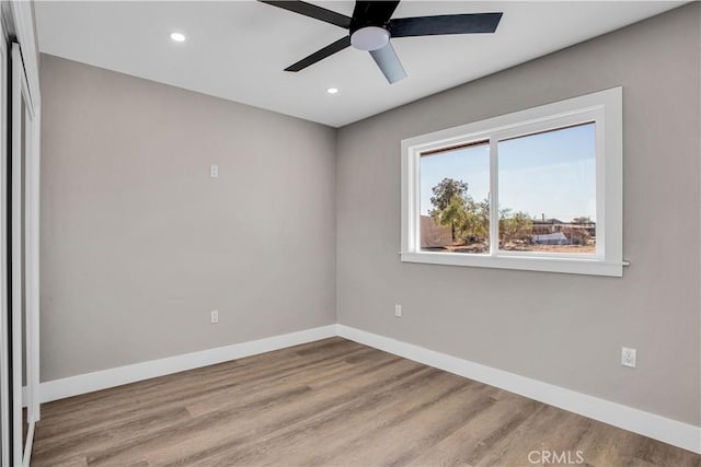 empty room with ceiling fan and light wood-type flooring