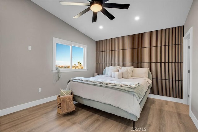 bedroom featuring ceiling fan, lofted ceiling, and light wood-type flooring