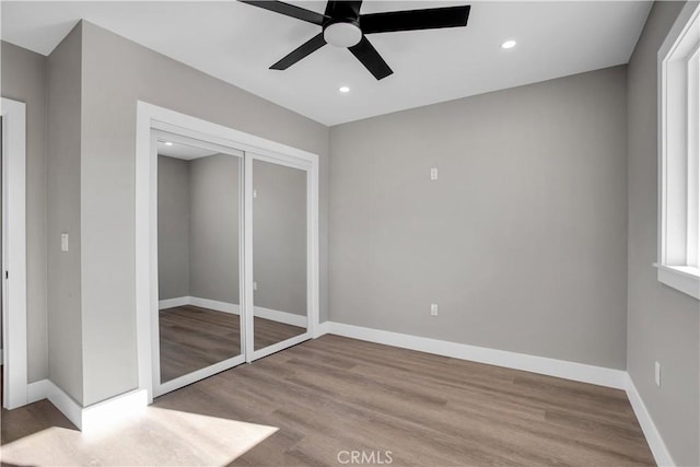 unfurnished bedroom featuring light wood-type flooring, a closet, and ceiling fan