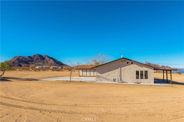 rear view of house featuring a mountain view