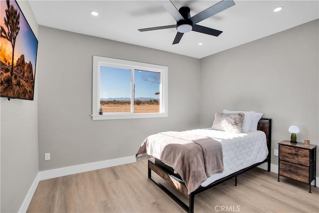 bedroom featuring ceiling fan and light hardwood / wood-style flooring