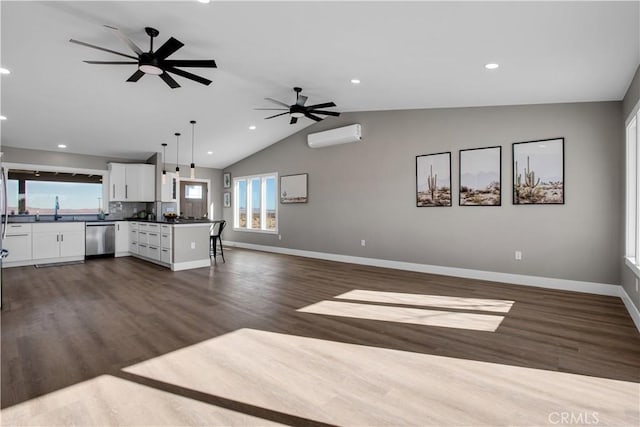 kitchen with kitchen peninsula, backsplash, pendant lighting, stainless steel dishwasher, and white cabinets