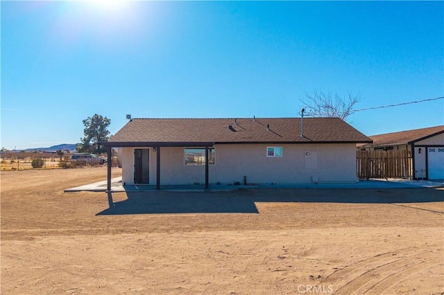 back of house featuring a garage