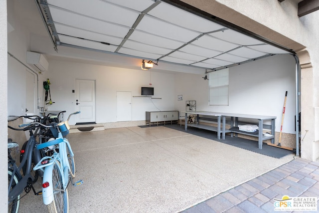 garage featuring a garage door opener and a wall unit AC