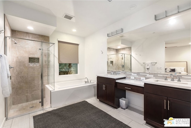 bathroom with shower with separate bathtub, vanity, and tile patterned flooring