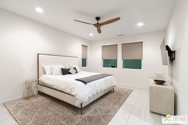 bedroom with ceiling fan and light tile patterned floors