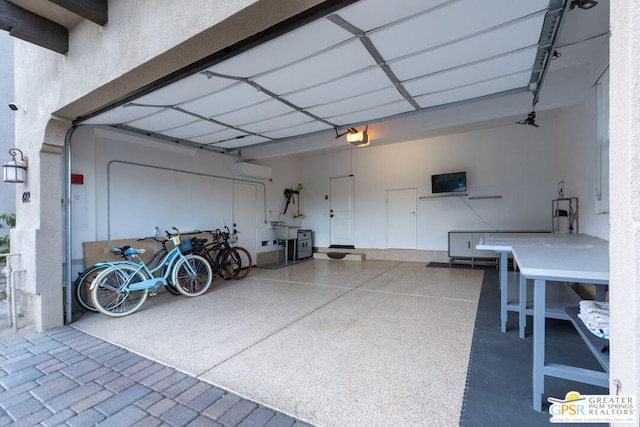 garage featuring an AC wall unit, a carport, and a garage door opener