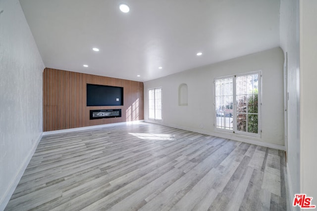 unfurnished living room with light hardwood / wood-style flooring