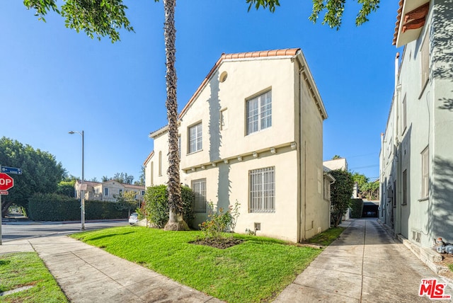 view of property exterior featuring a lawn