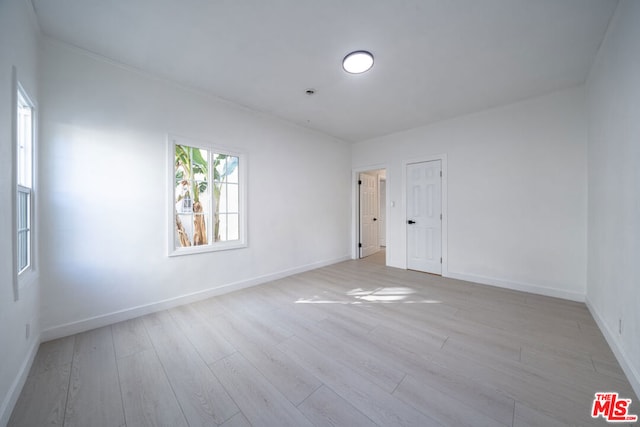 spare room with light hardwood / wood-style floors