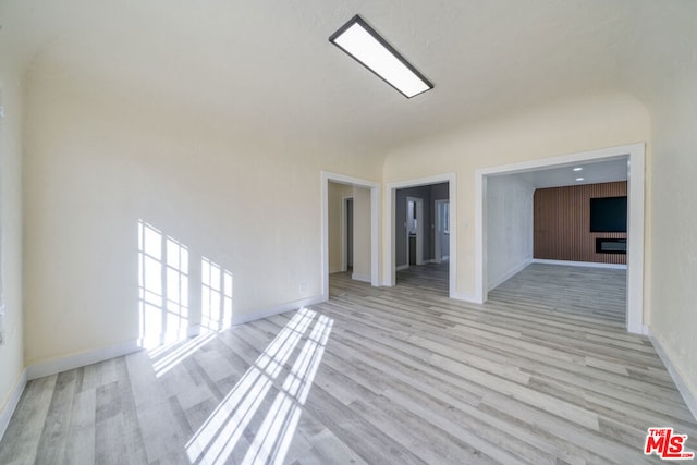 empty room with light hardwood / wood-style flooring