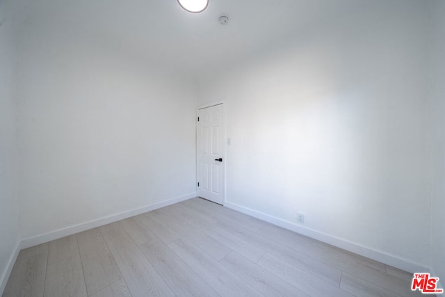 spare room with light wood-type flooring