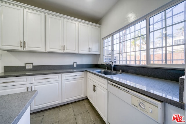 kitchen featuring sink, white cabinets, and dishwasher