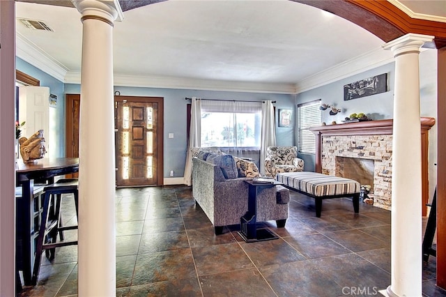 living room featuring crown molding, a fireplace, and decorative columns