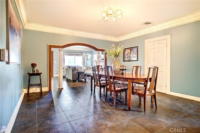 dining area featuring ornamental molding and ornate columns