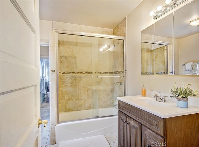 bathroom with tile patterned flooring, enclosed tub / shower combo, and vanity