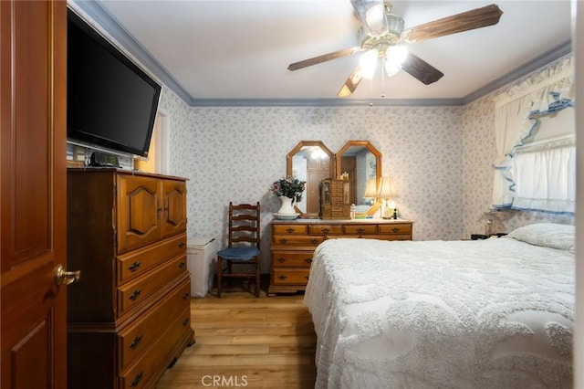 bedroom with ceiling fan, ornamental molding, and light wood-type flooring