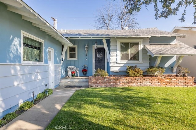 view of exterior entry with a lawn